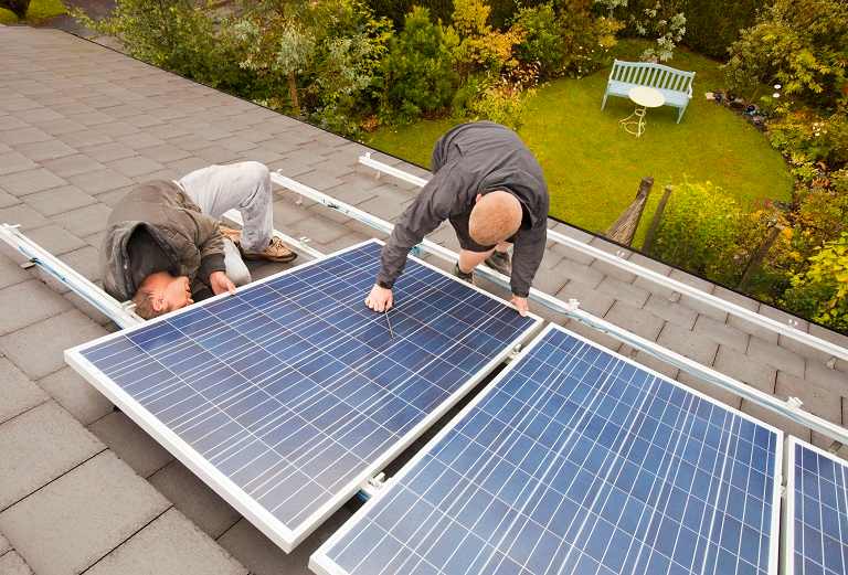 Men repairing a solar panel