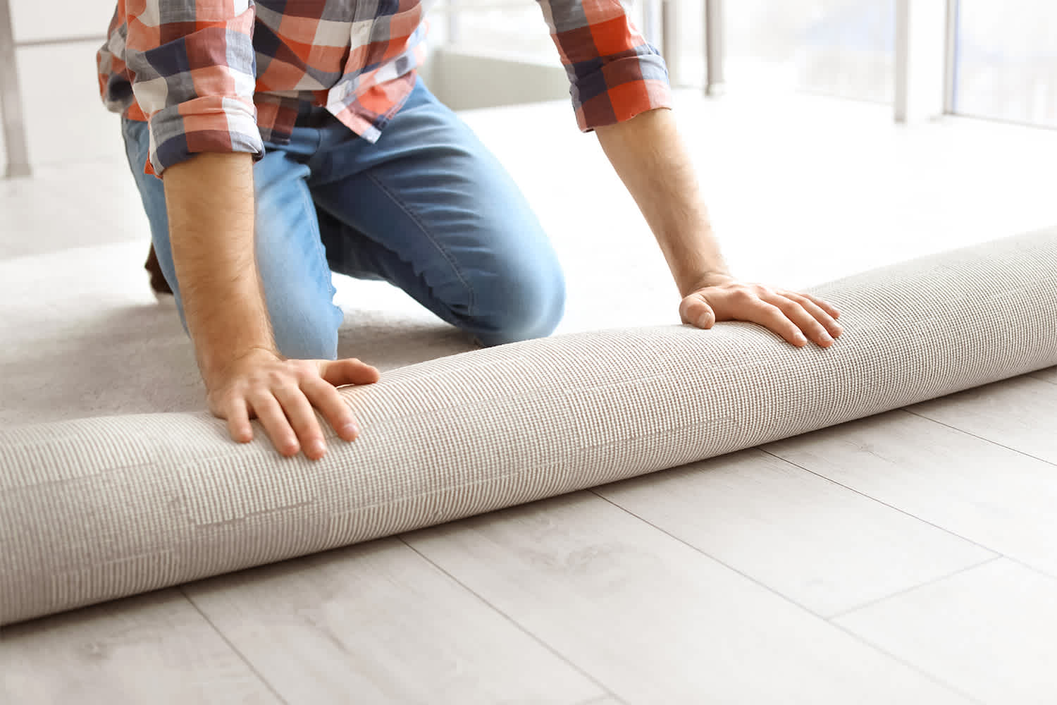 Man installing carpet in his home