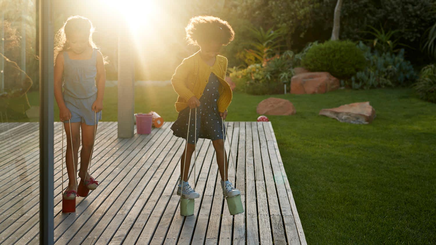 Two children playing on a wooden deck