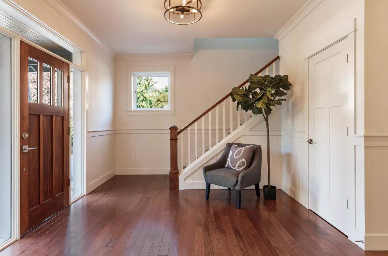 A house entrance with hardwood floor