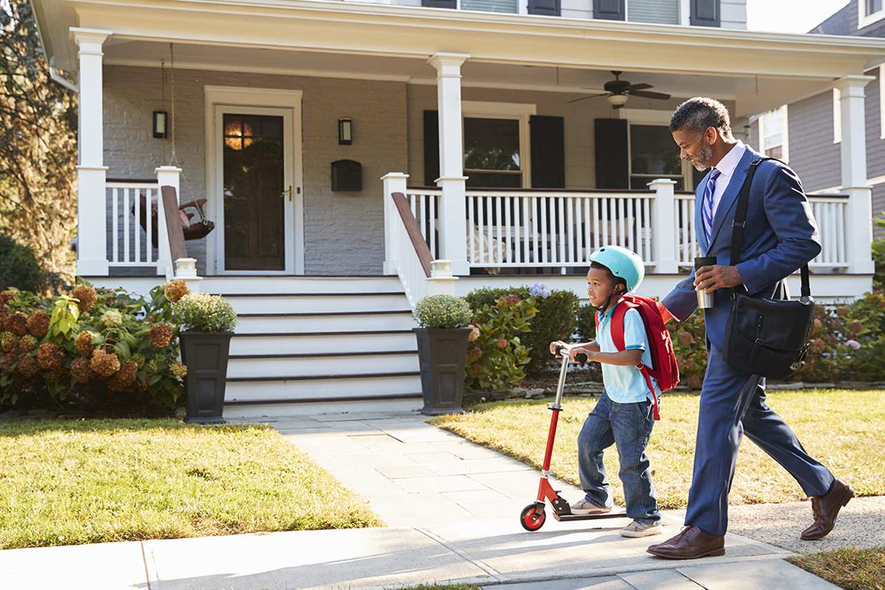 father and son walking on sidewalk