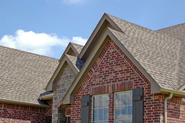 gray brown roof with brick siding and windows