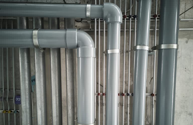 a collection of silver pipes making up a home sewer line