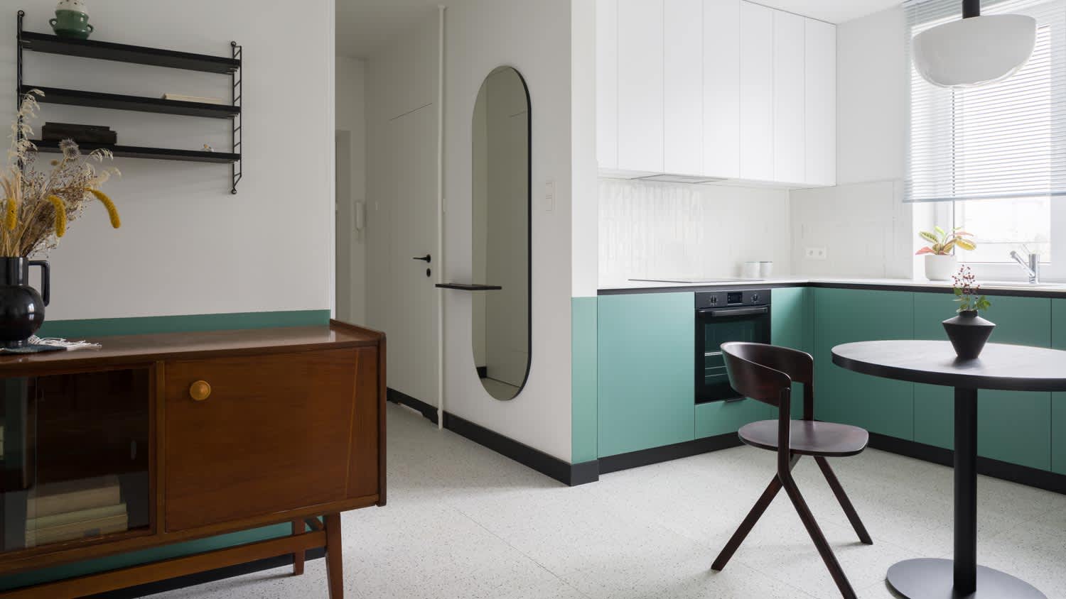 A vintage kitchen with a black baseboard