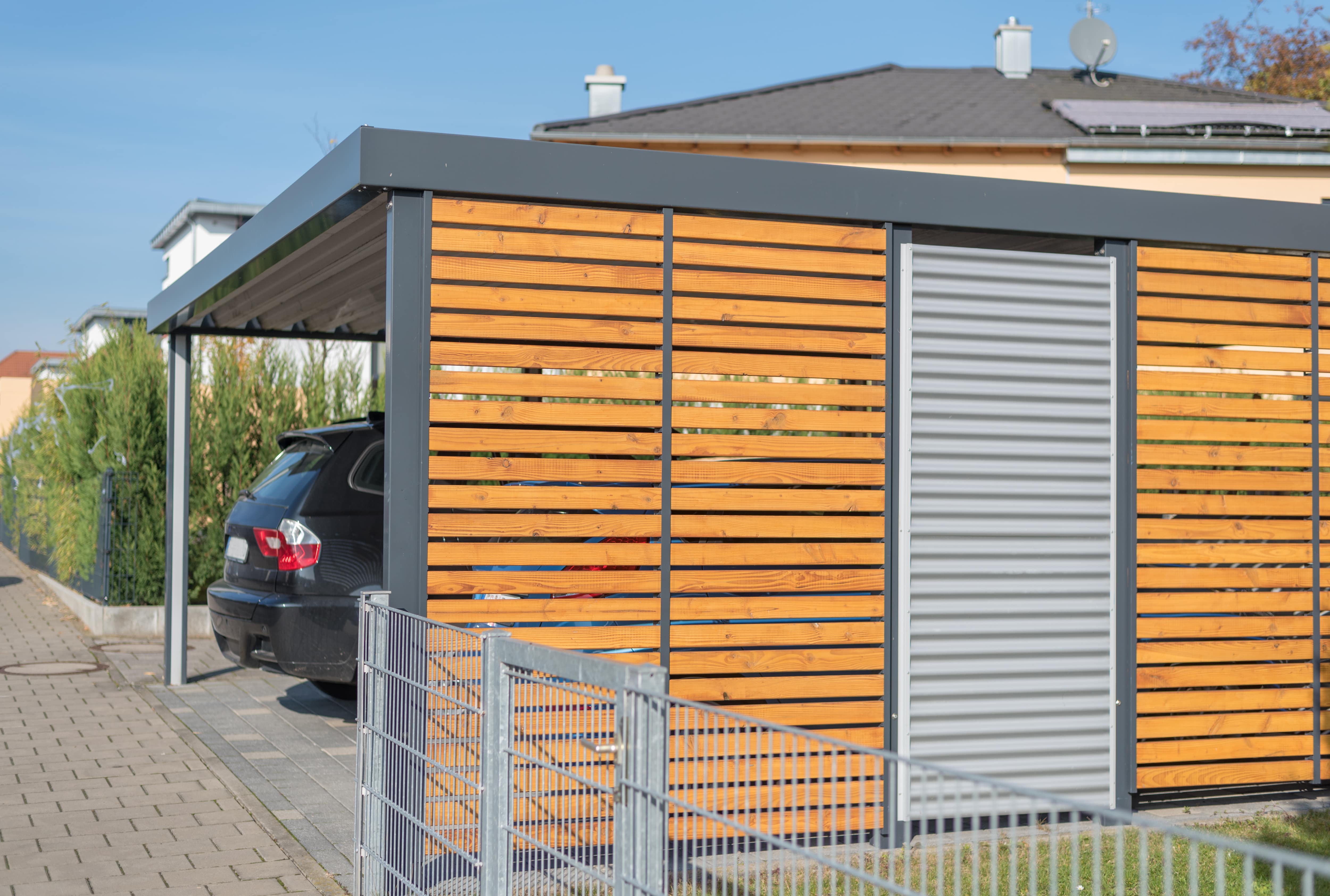 Modern carport built from wood and aluminum panels