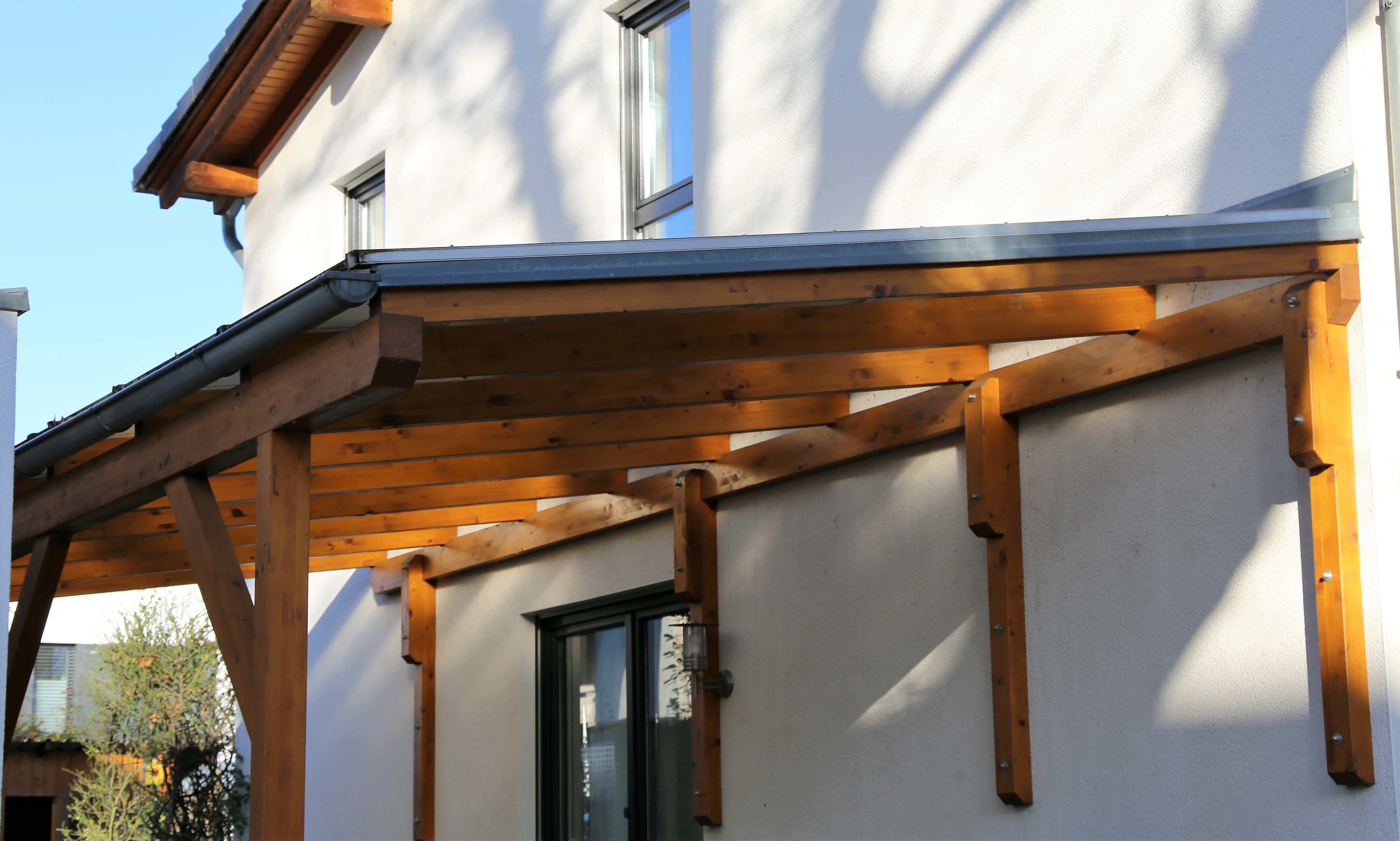 Attached carport built from wooden beams