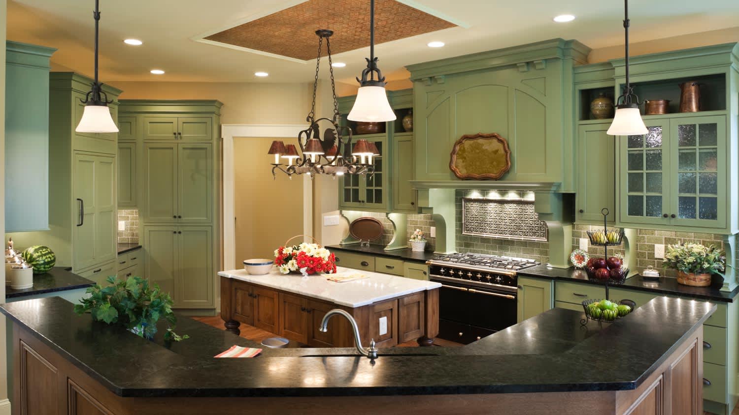 A country style kitchen with an old table used as kitchen island