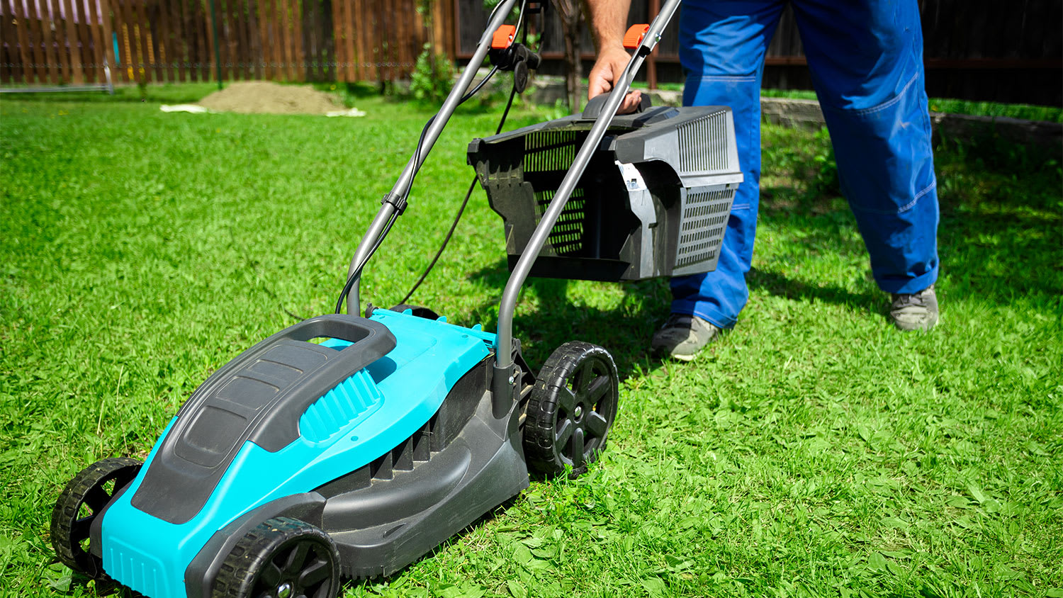 Man removing basket from lawn mower