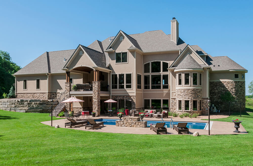 Luxury suburban home with stone exterior