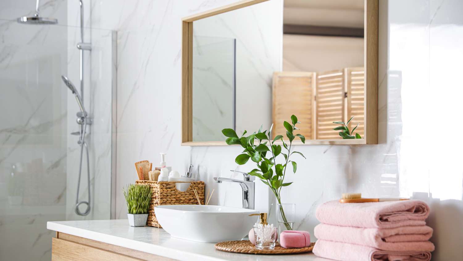 A large mirror over the sink in a modern bathroom