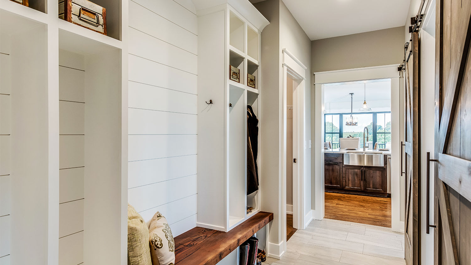 A view of a mudroom with shiplap