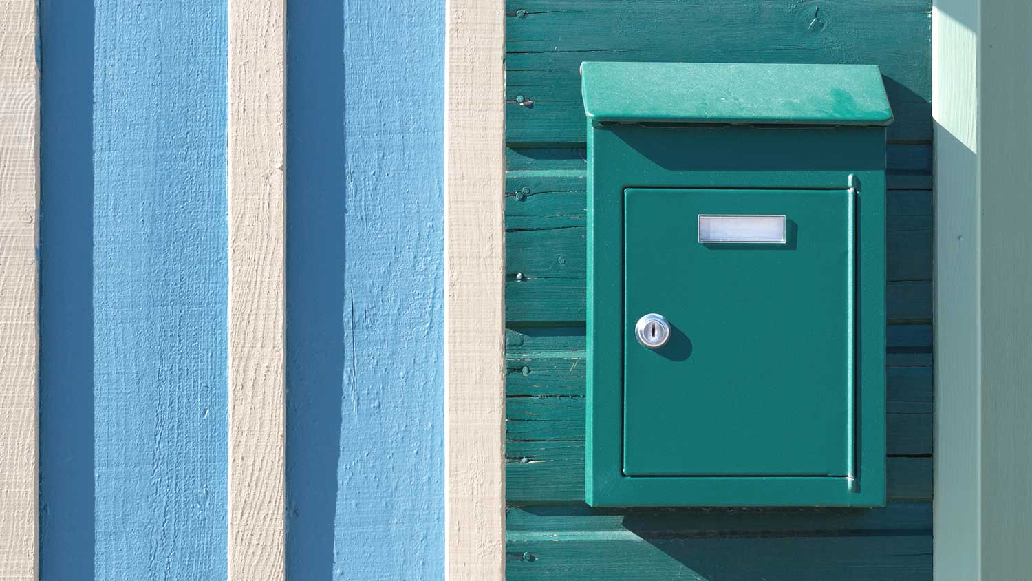 Turquoise mailbox mounted on a wall