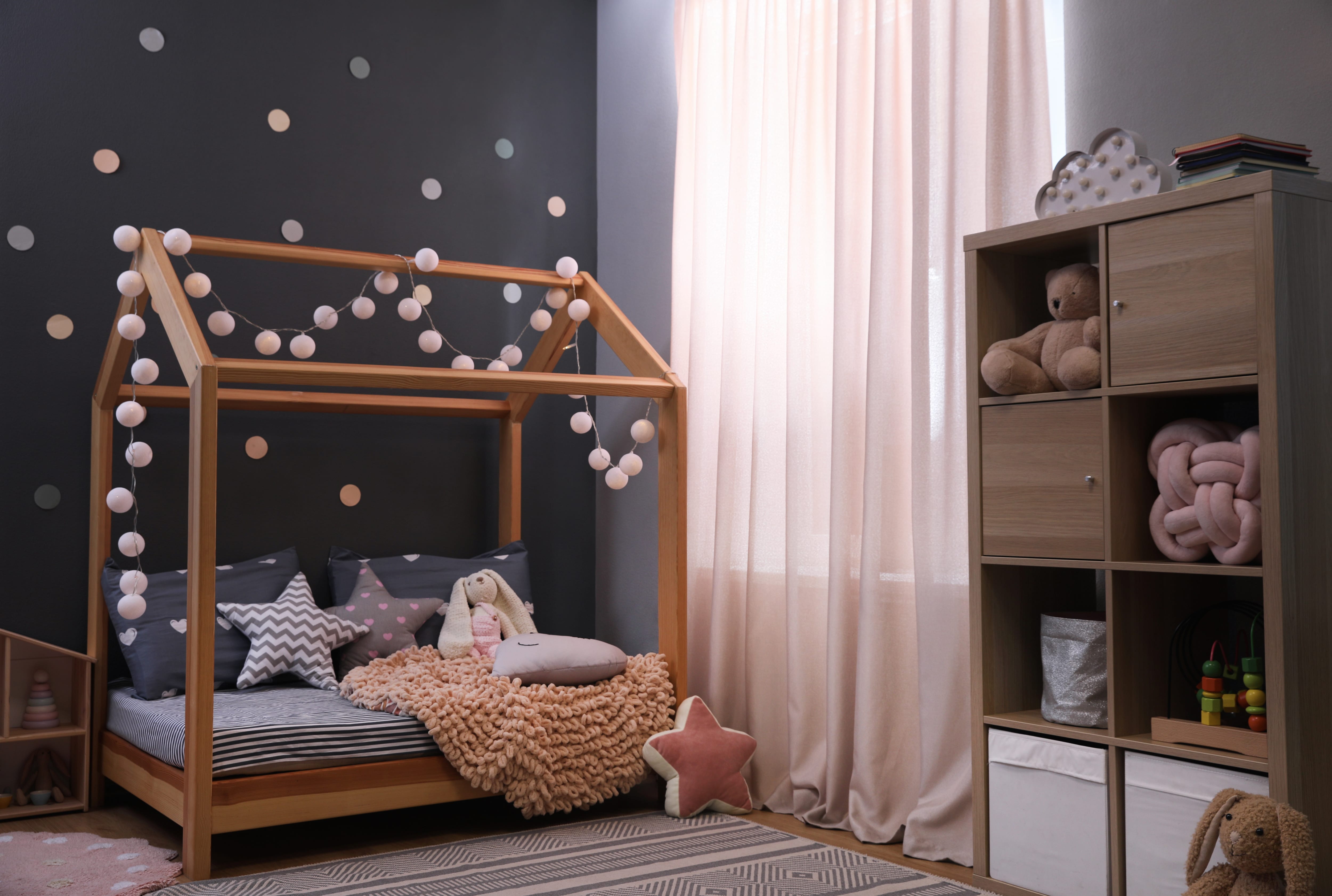 Trendy child’s room with large window