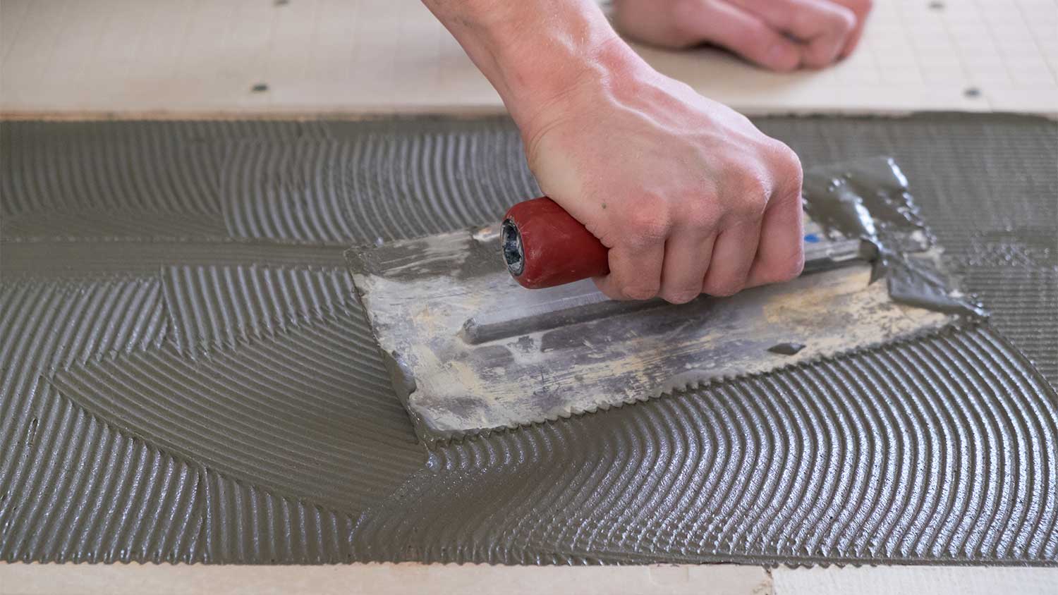 A closeup of mortar being spread
