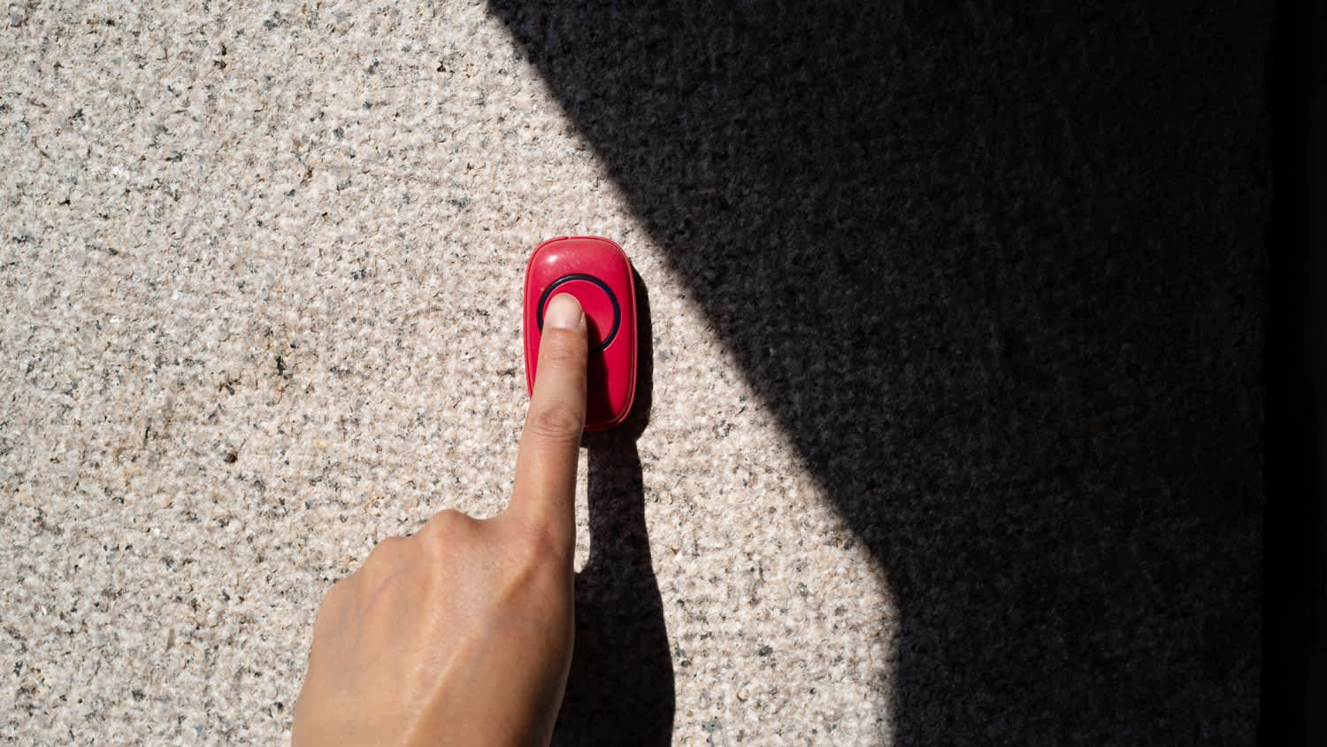 Detail of a hand ringing a doorbell