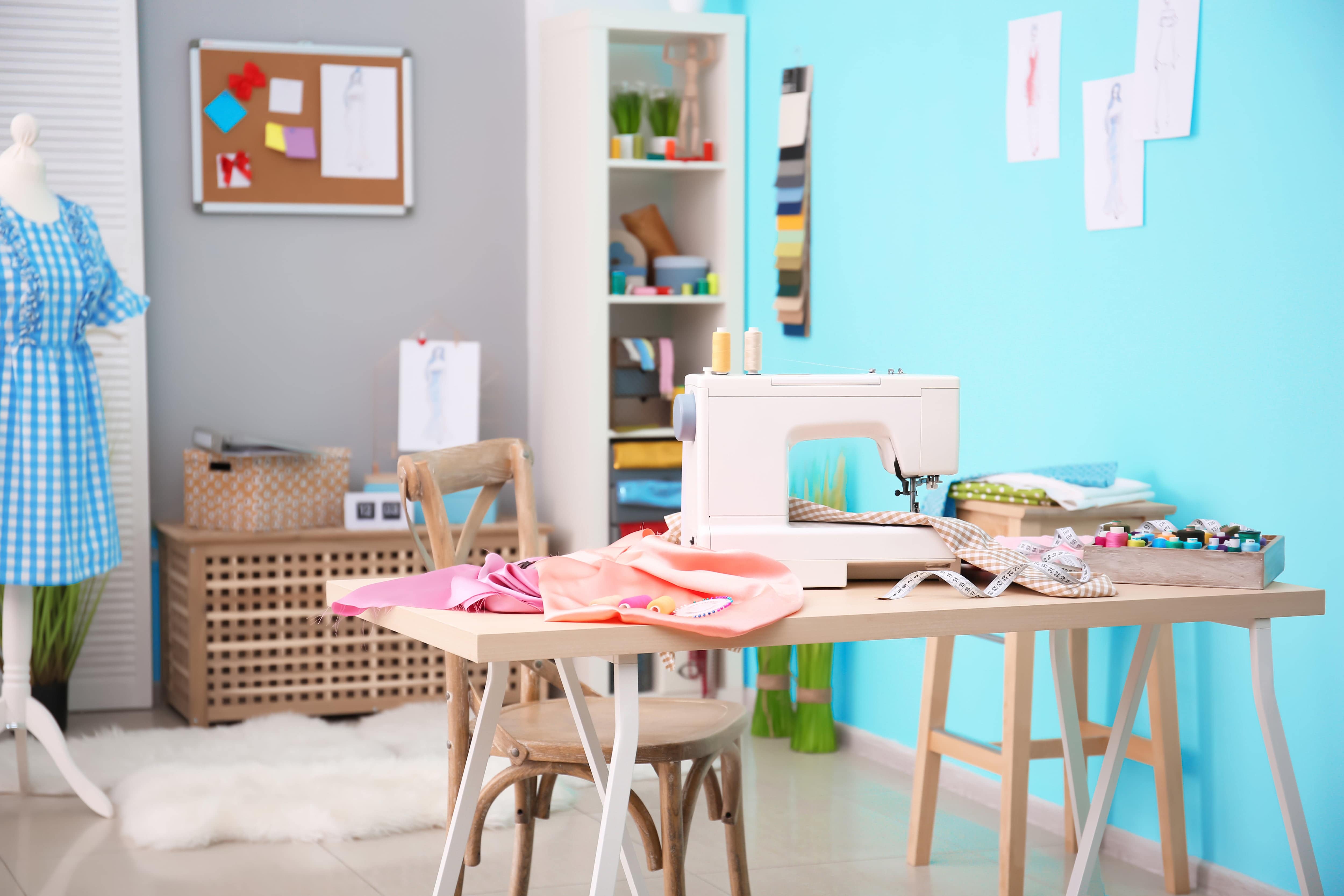 Bright craft room with shelving, work table, and sewing machine