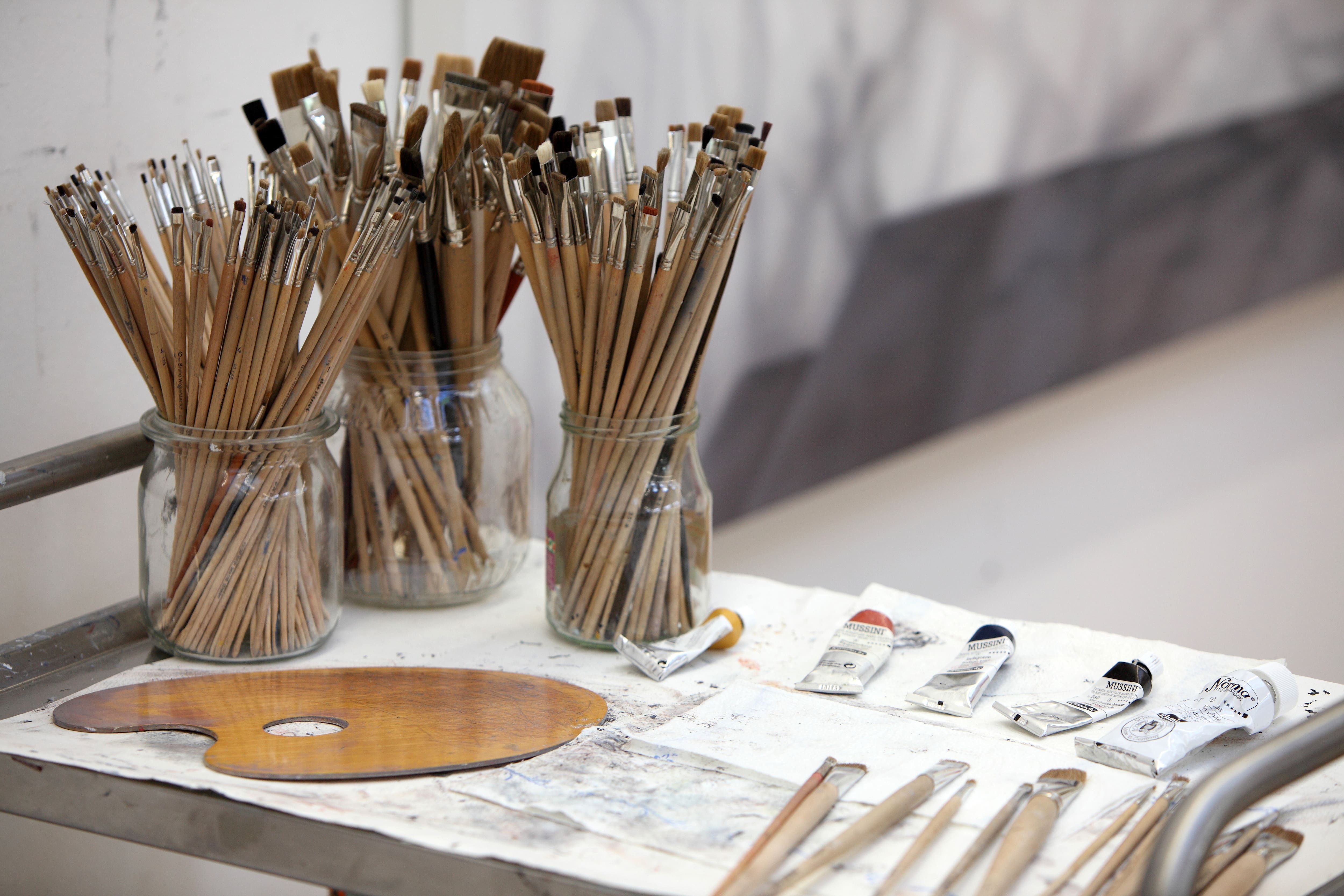 Glass jars with different size paintbrushes