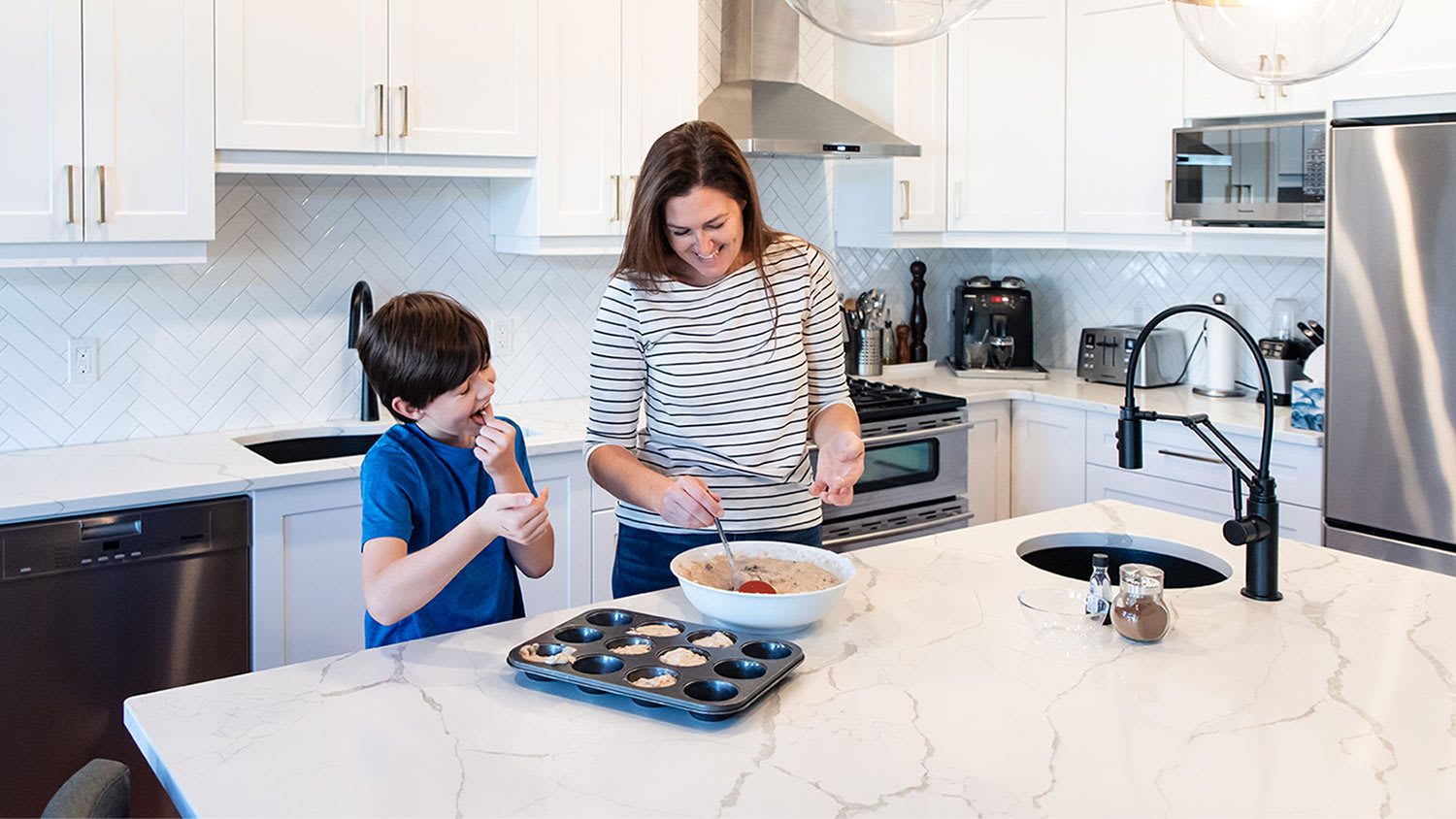 mother and son baking in kitchen on quartz countertop