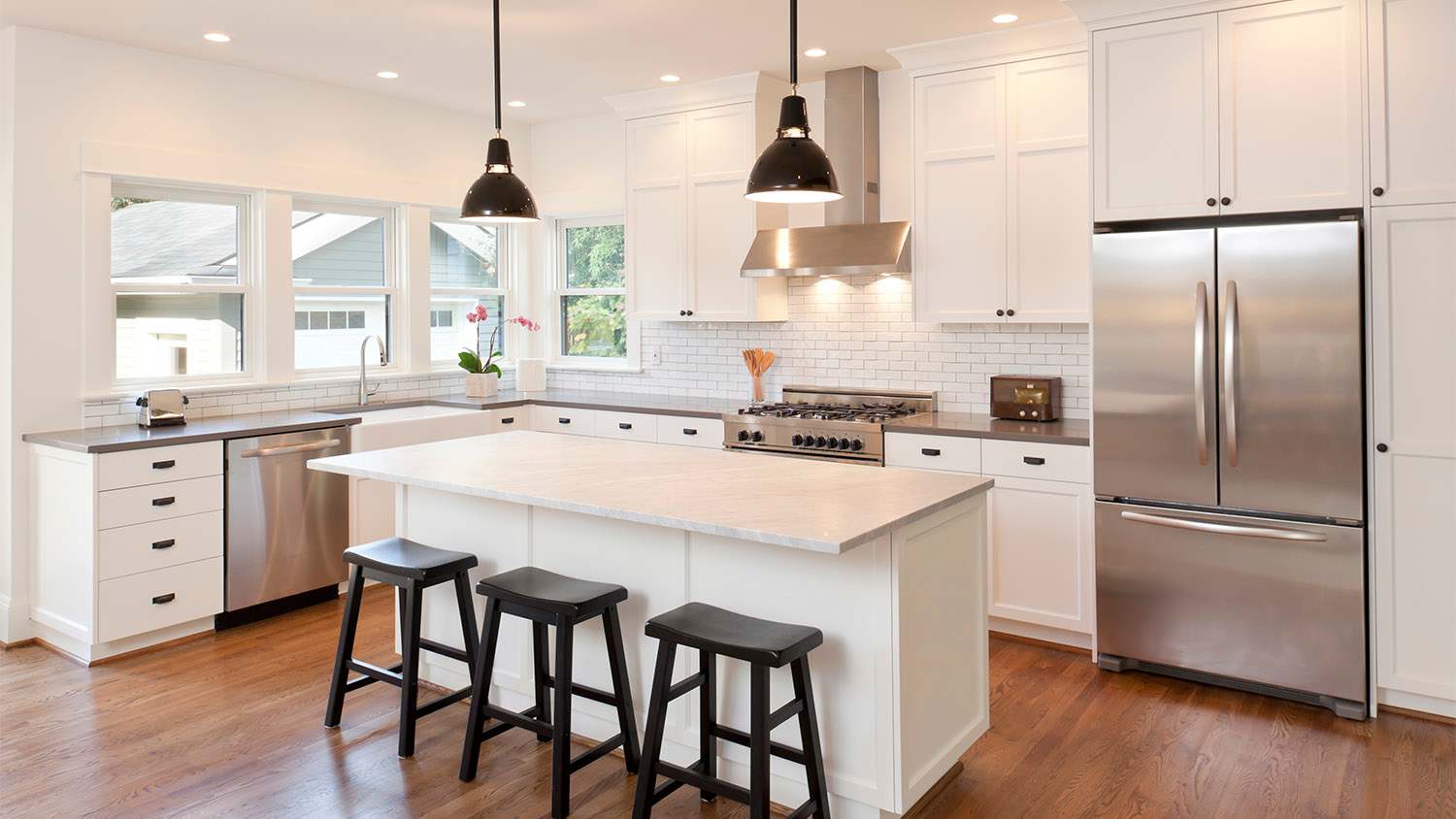 kitchen with white cabinets and a variety of black hardware