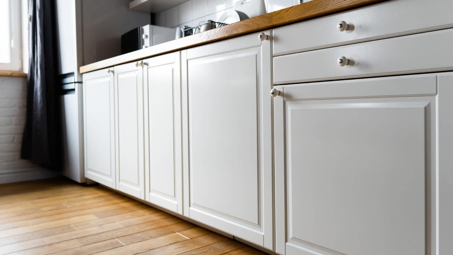 White cabinets with wooden countertop