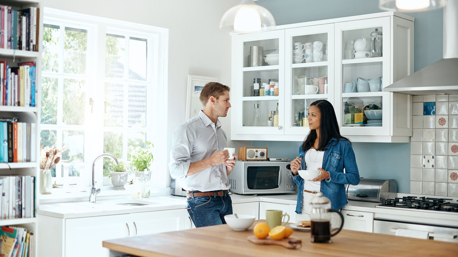 Couple talk in tidy, organized kitchen