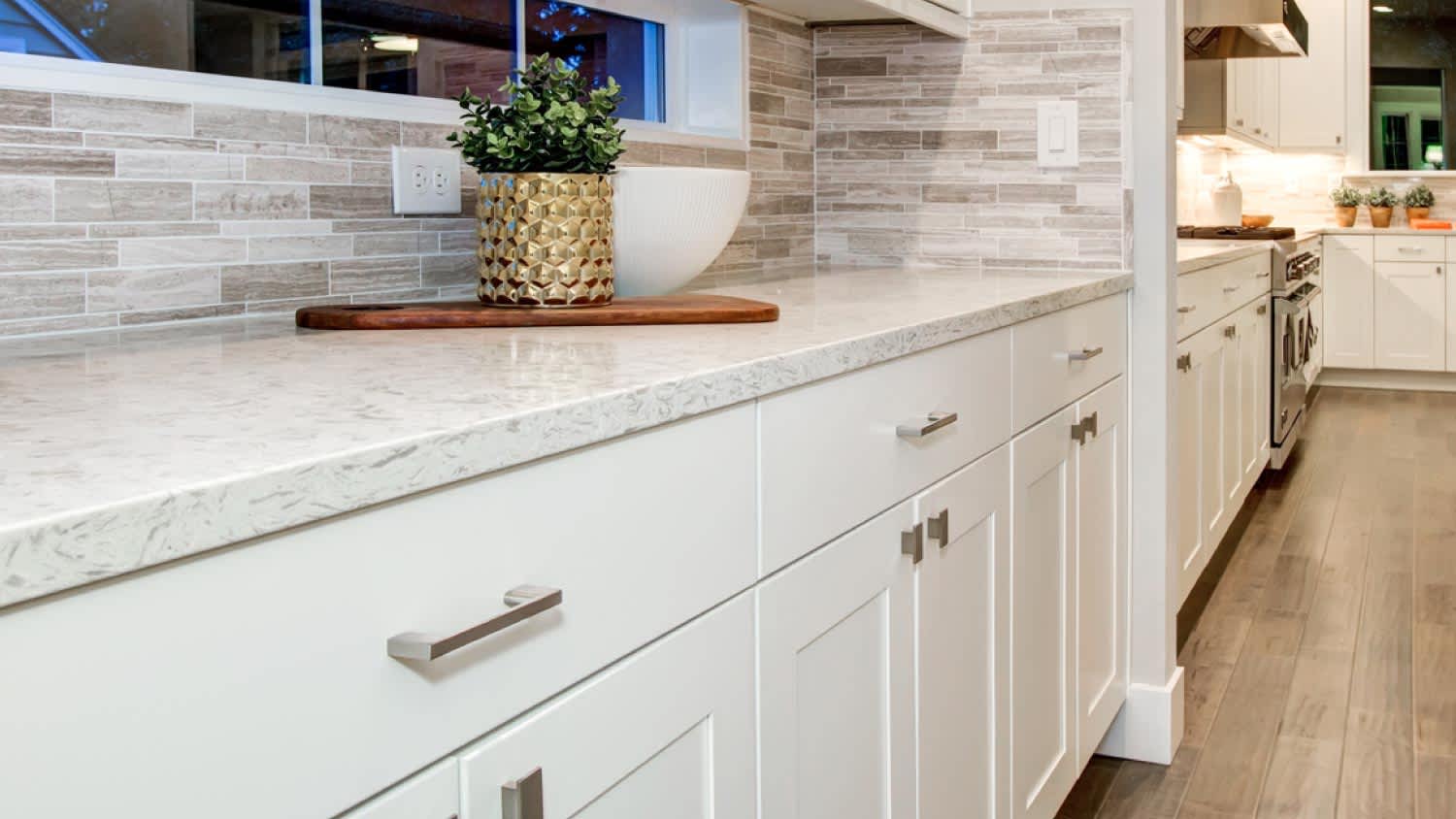 A kitchen with white modern cabinets