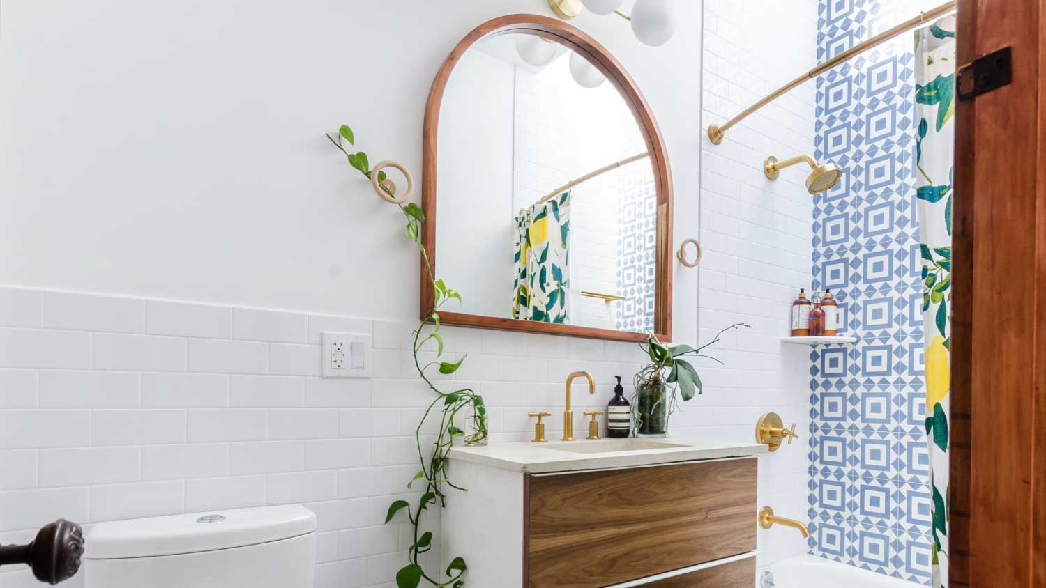 bright bathroom with arched mirror