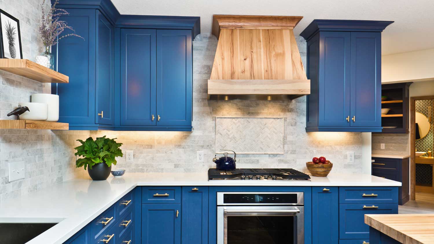 blue kitchen with wood hood range