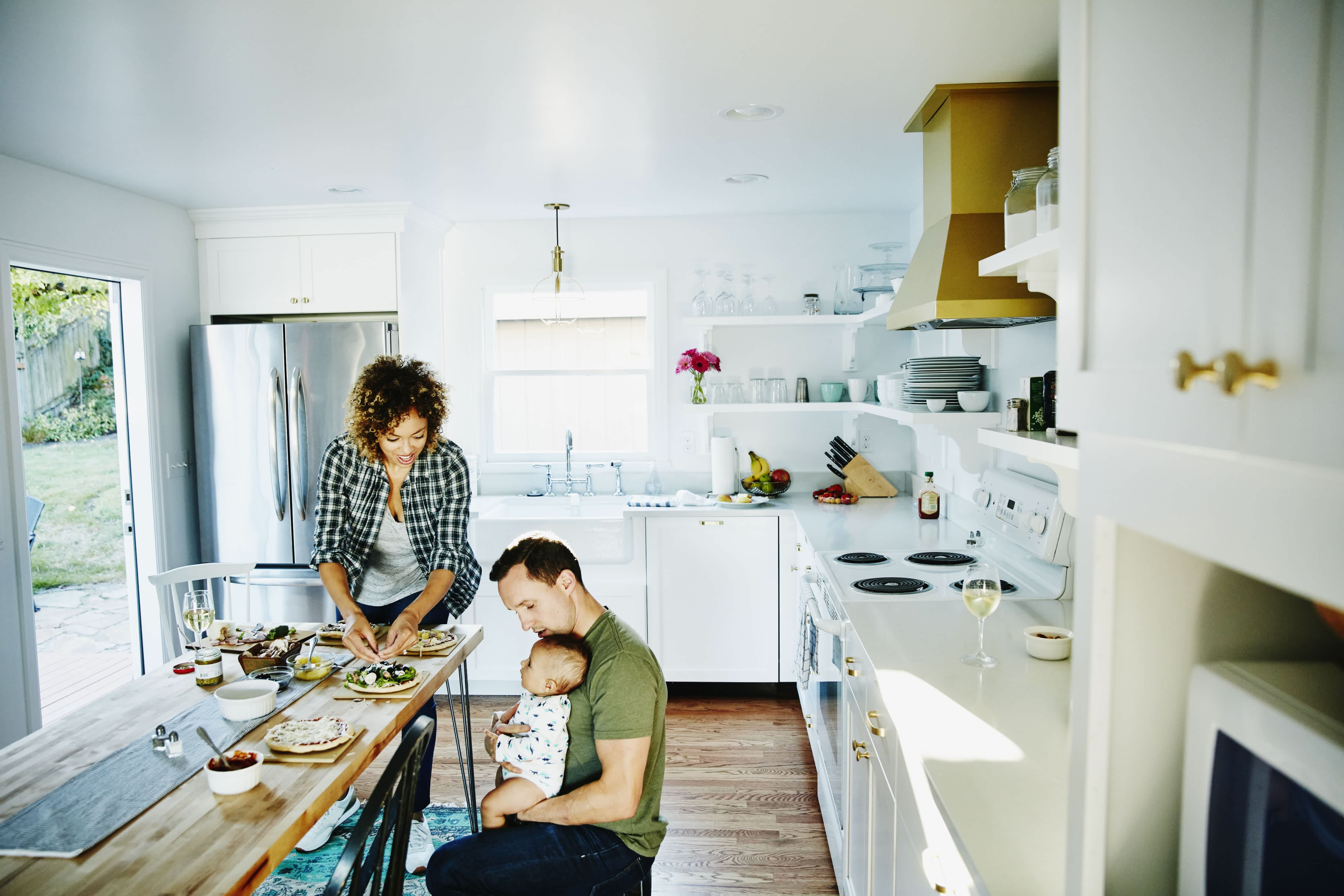 Happy diverse family in a white kitchen