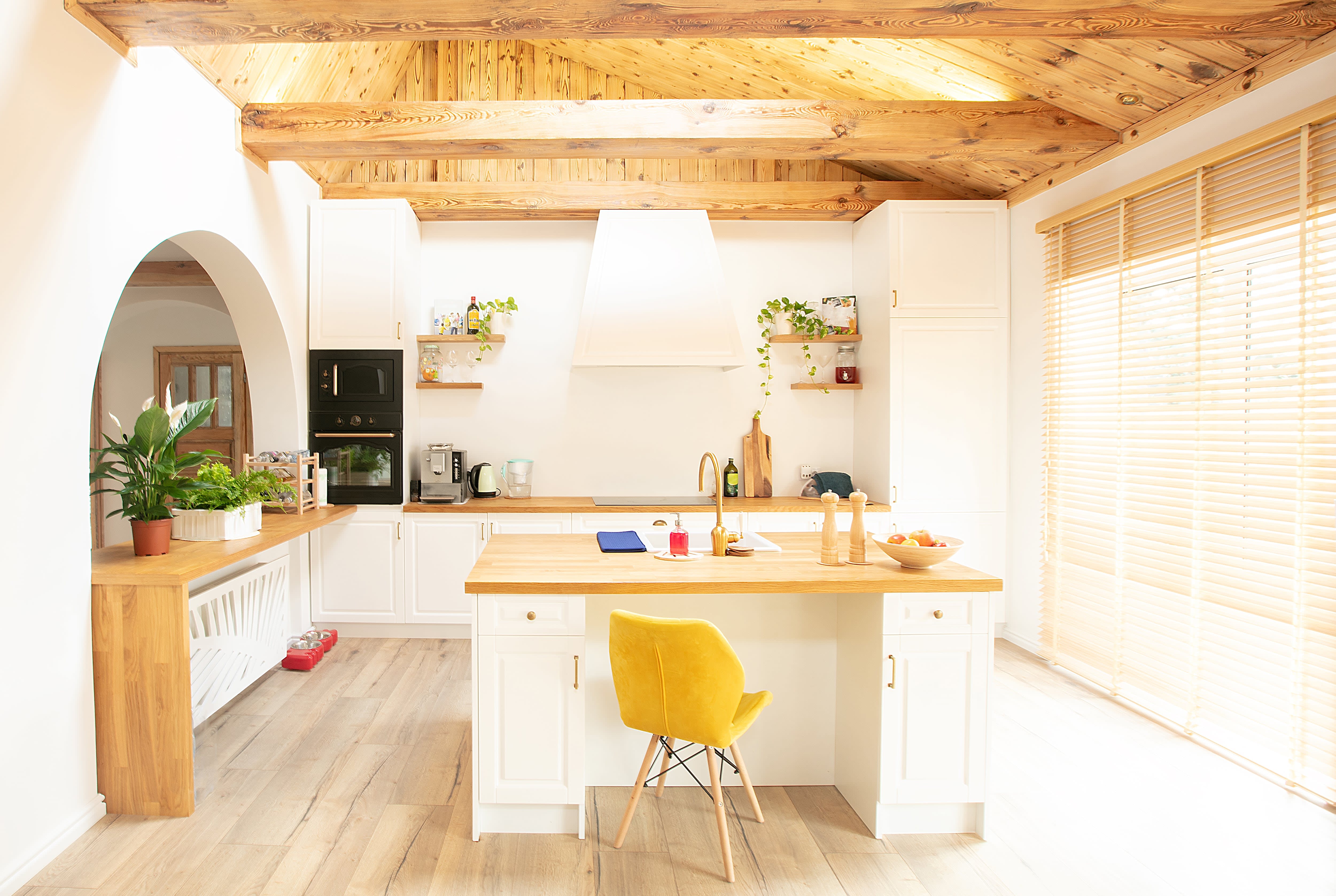 White kitchen with light wooden beams and matching countertops