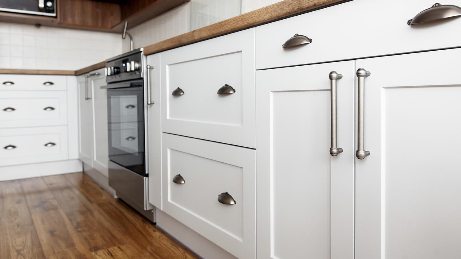 Stylish light gray handles on cabinets