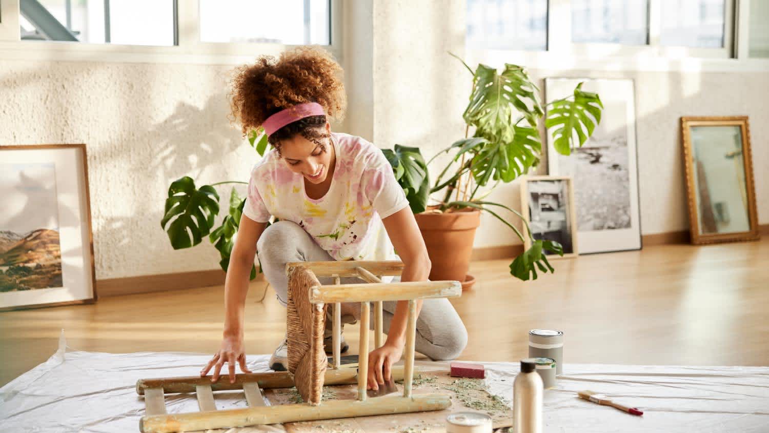 A woman cleaning a wooden chair