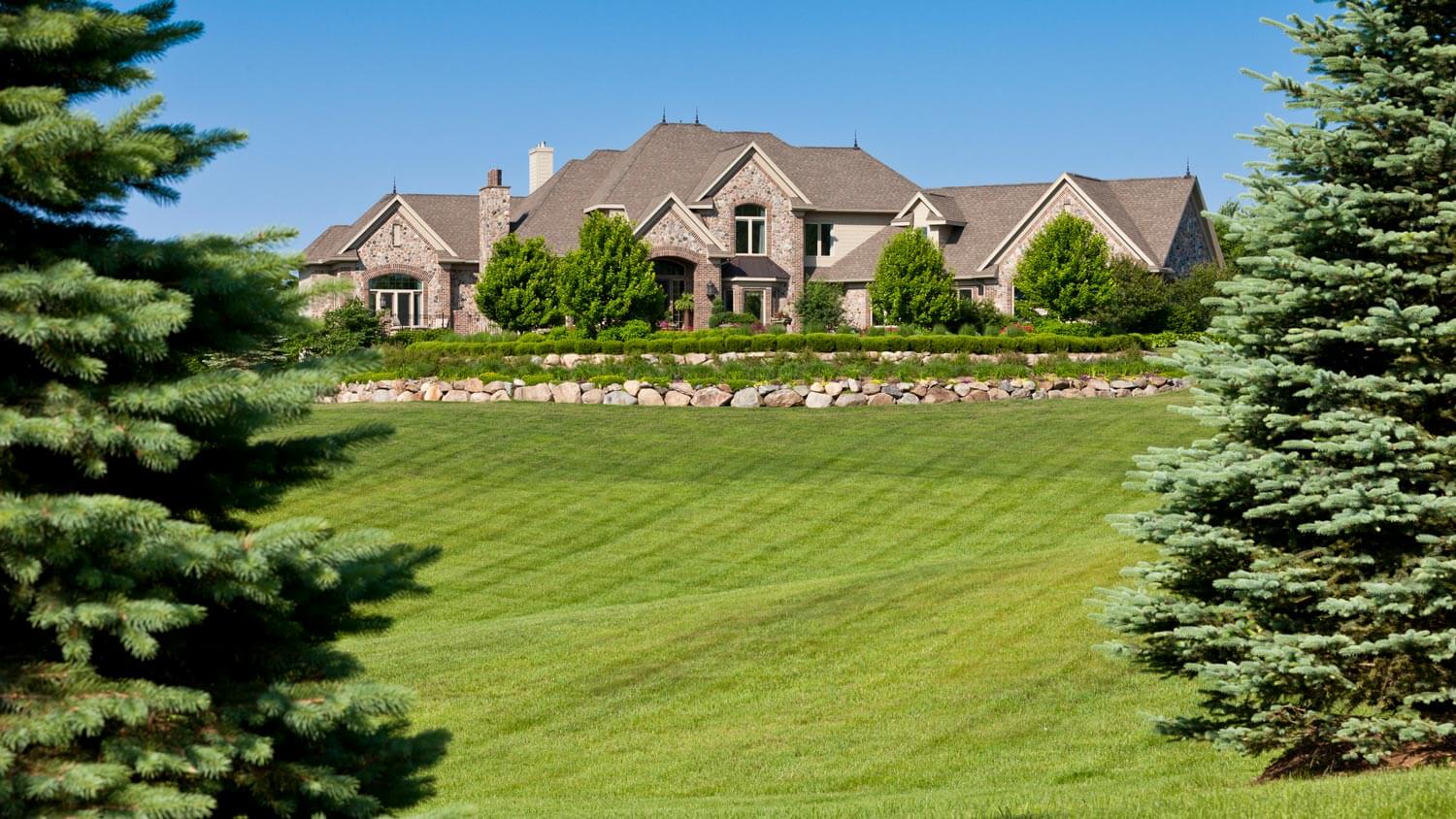 A villa with expansive grounds and pine trees