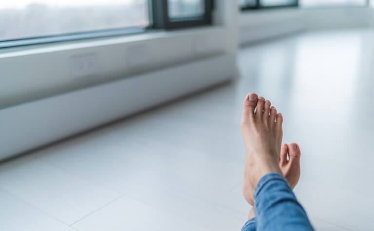 warm feet on a tile floor by a baseboard heater
