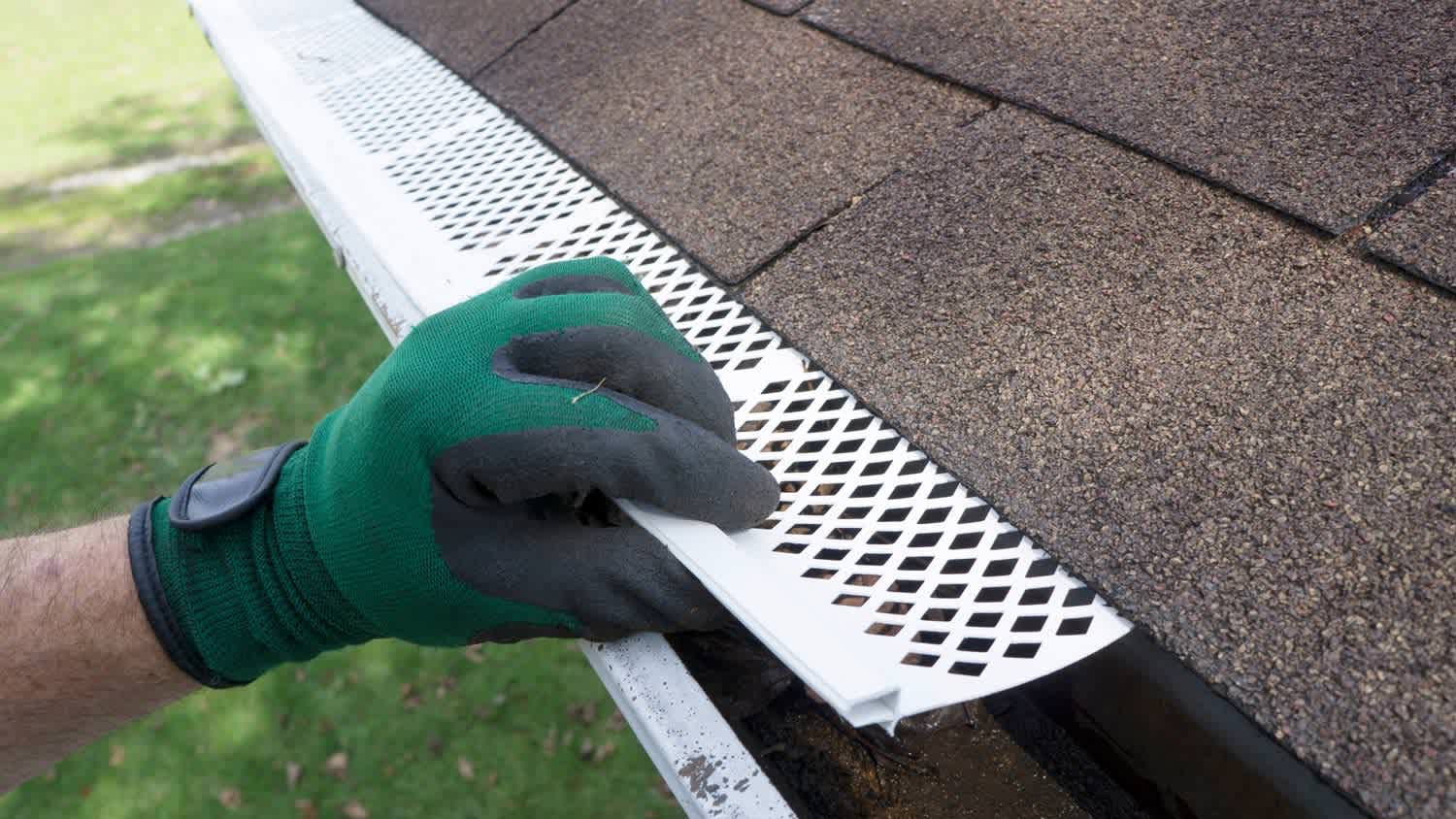 A worker installing gutter guards