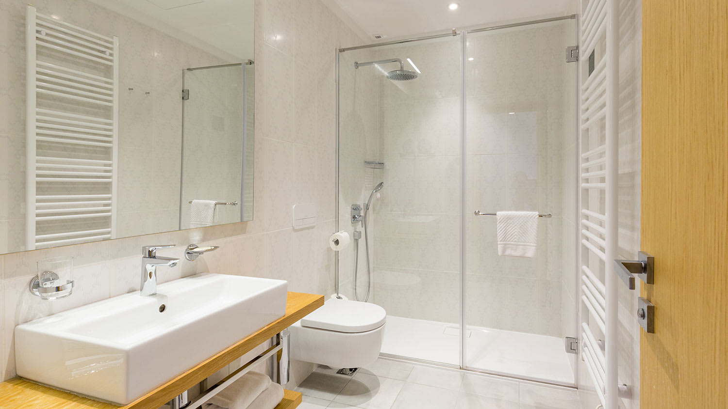 Bathroom with glass shower stall and white tiles