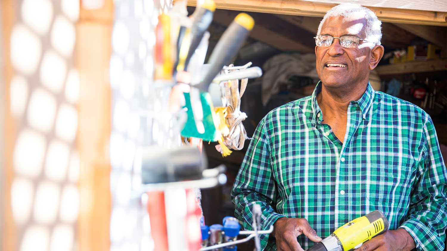 A man looks at a tool shed