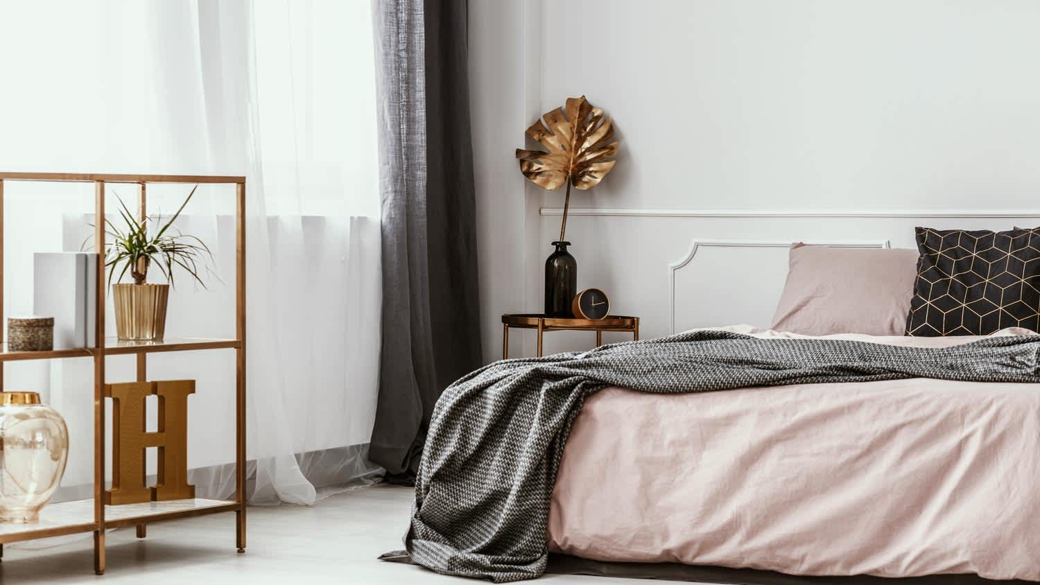 Wainscoting on wall of minimal bedroom with pastel bedding