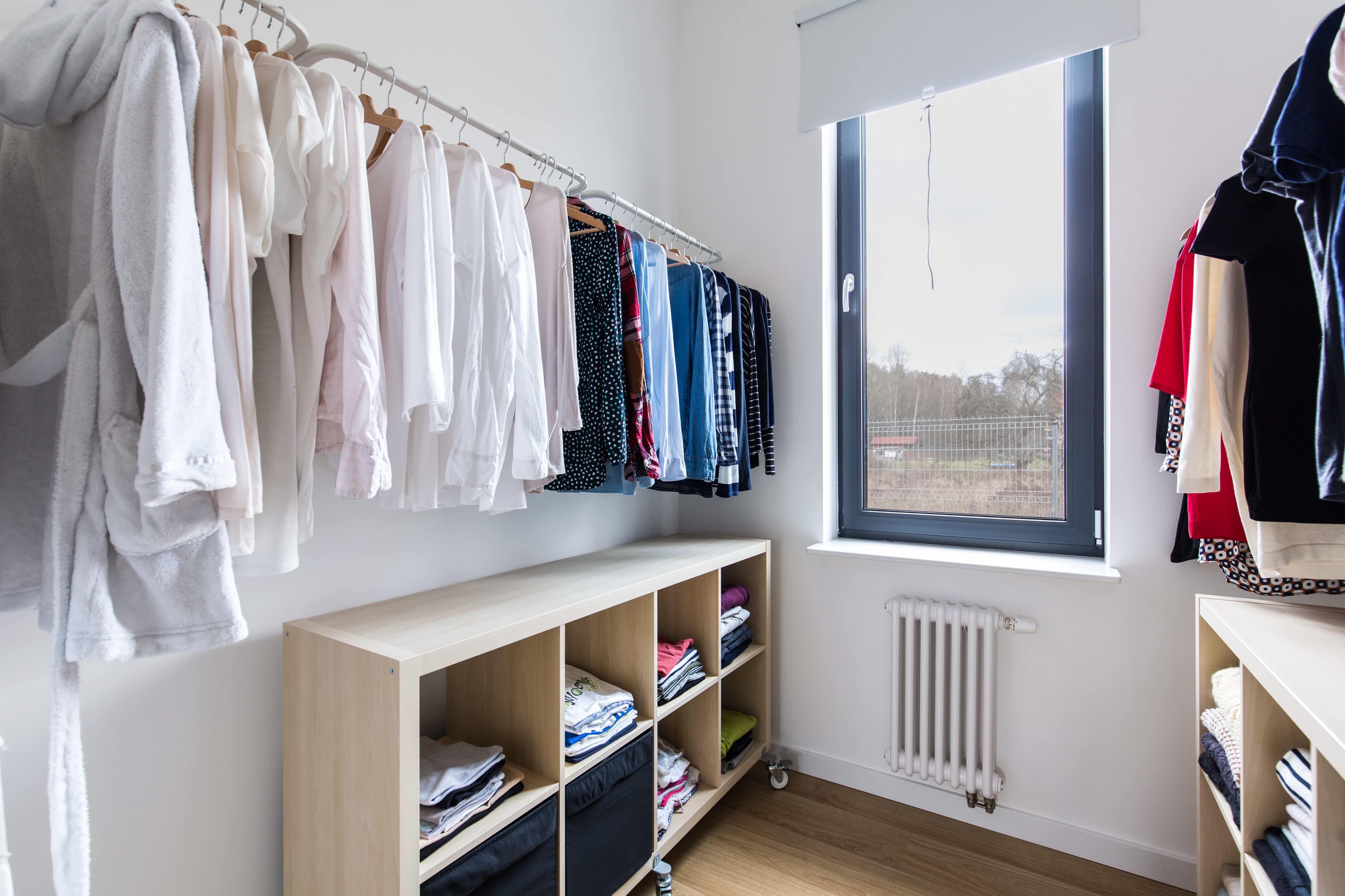 A brightly lit closet with two portable half-size bookshelves