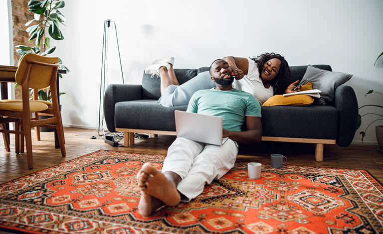 Couple sit on oriental rug