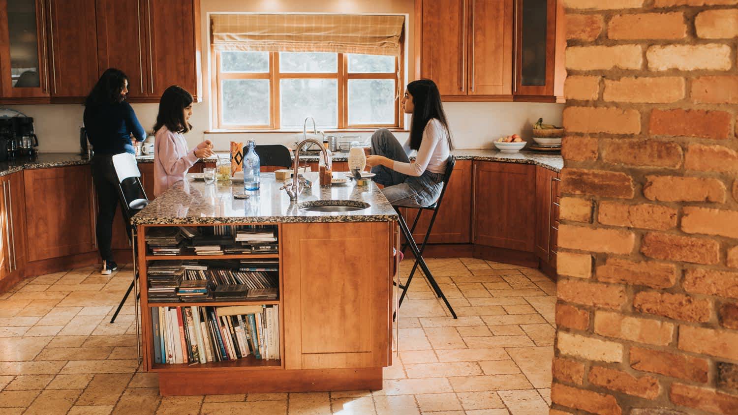 A family seating by a kitchen island enjoying a quick lunch