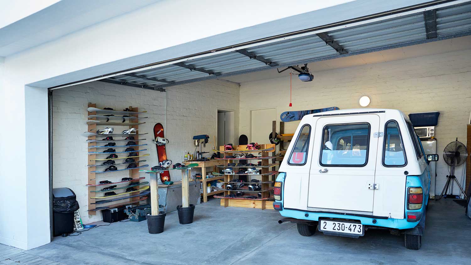 Garage and workshop with a van parked inside