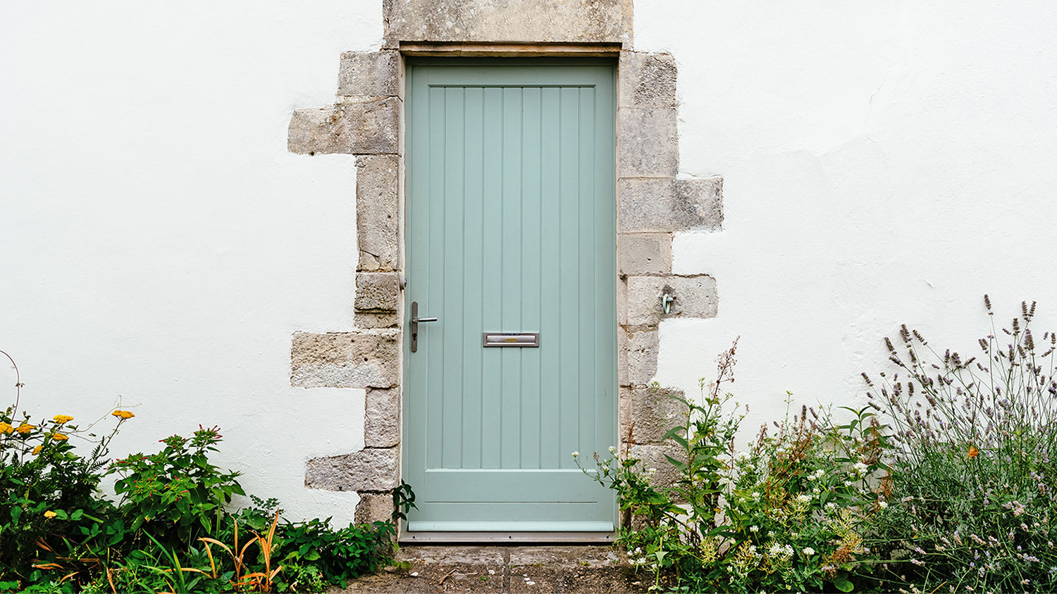 green wooden door on lintel