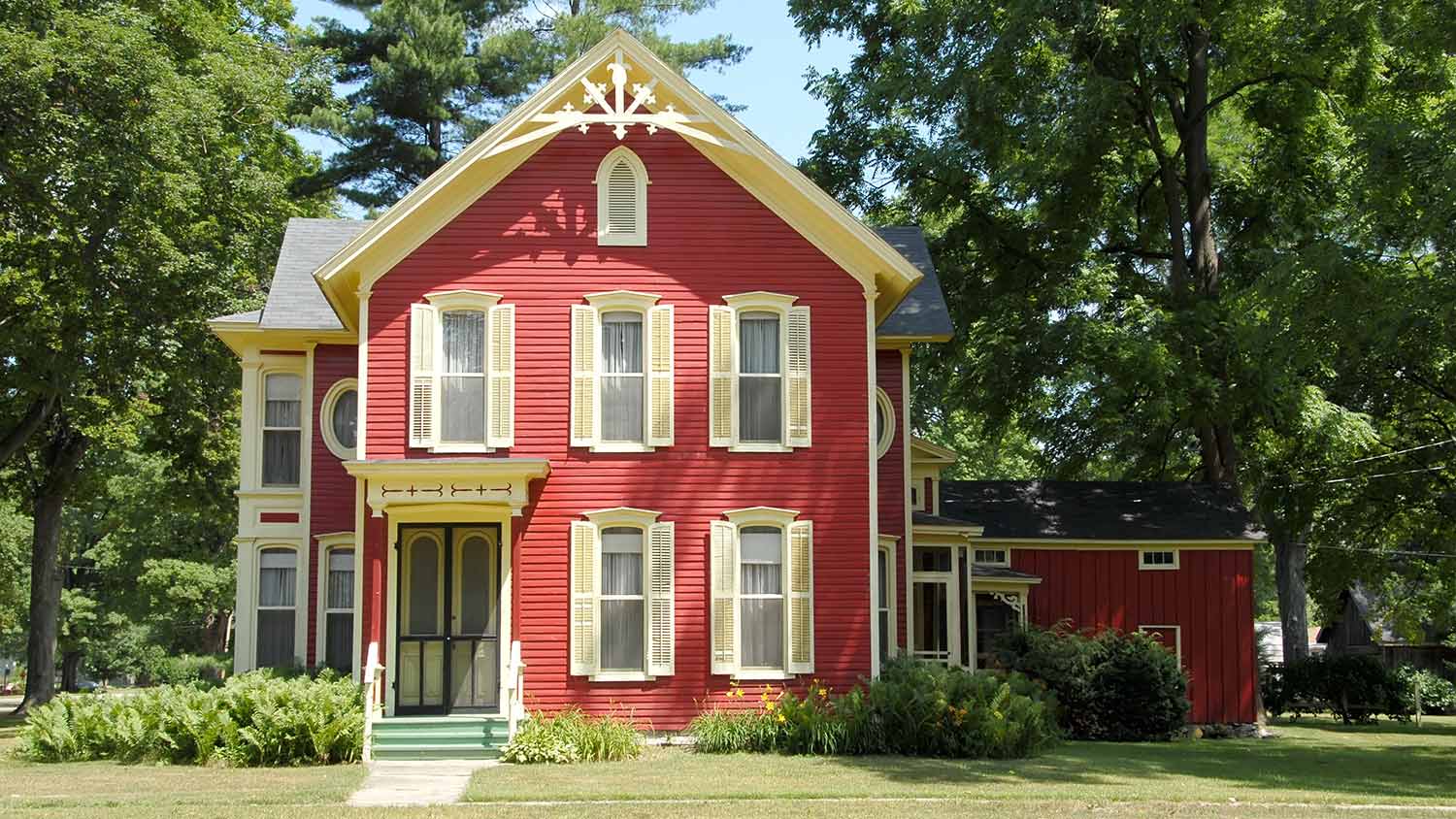 Red Victorian home in peaceful setting