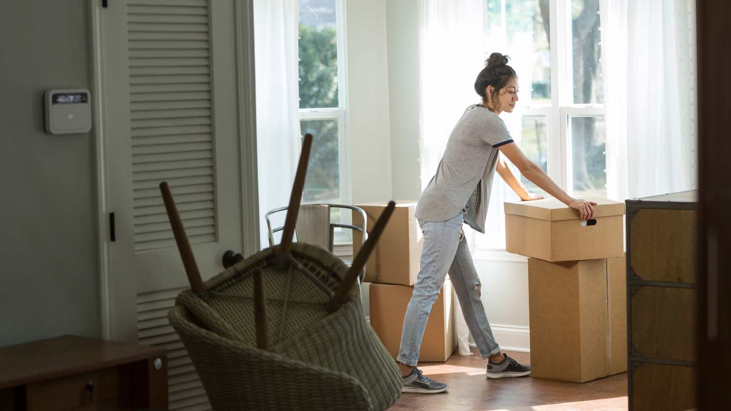 A young woman moving in a new house
