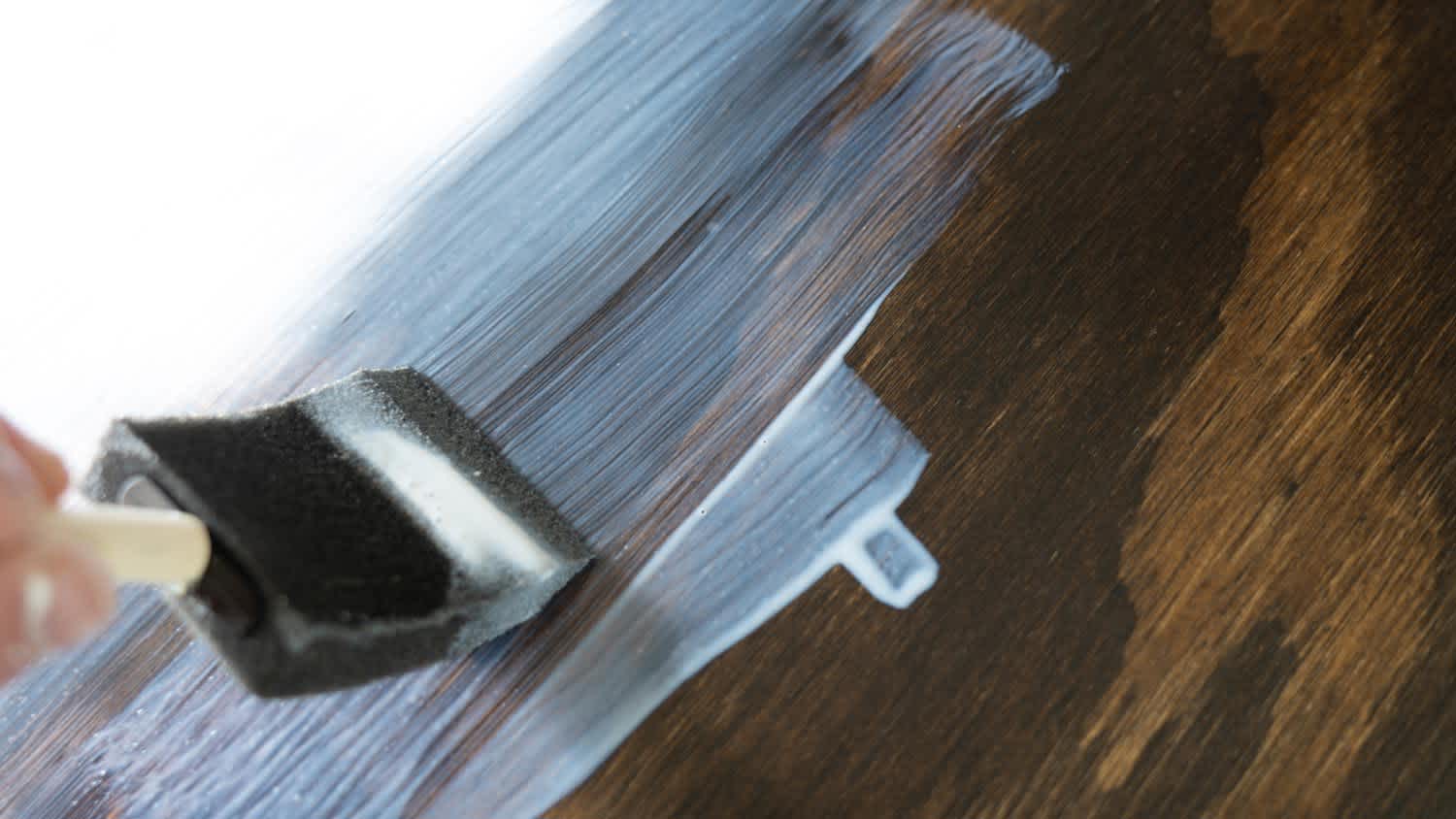Close-up of a brush applying a polycrilic sealant