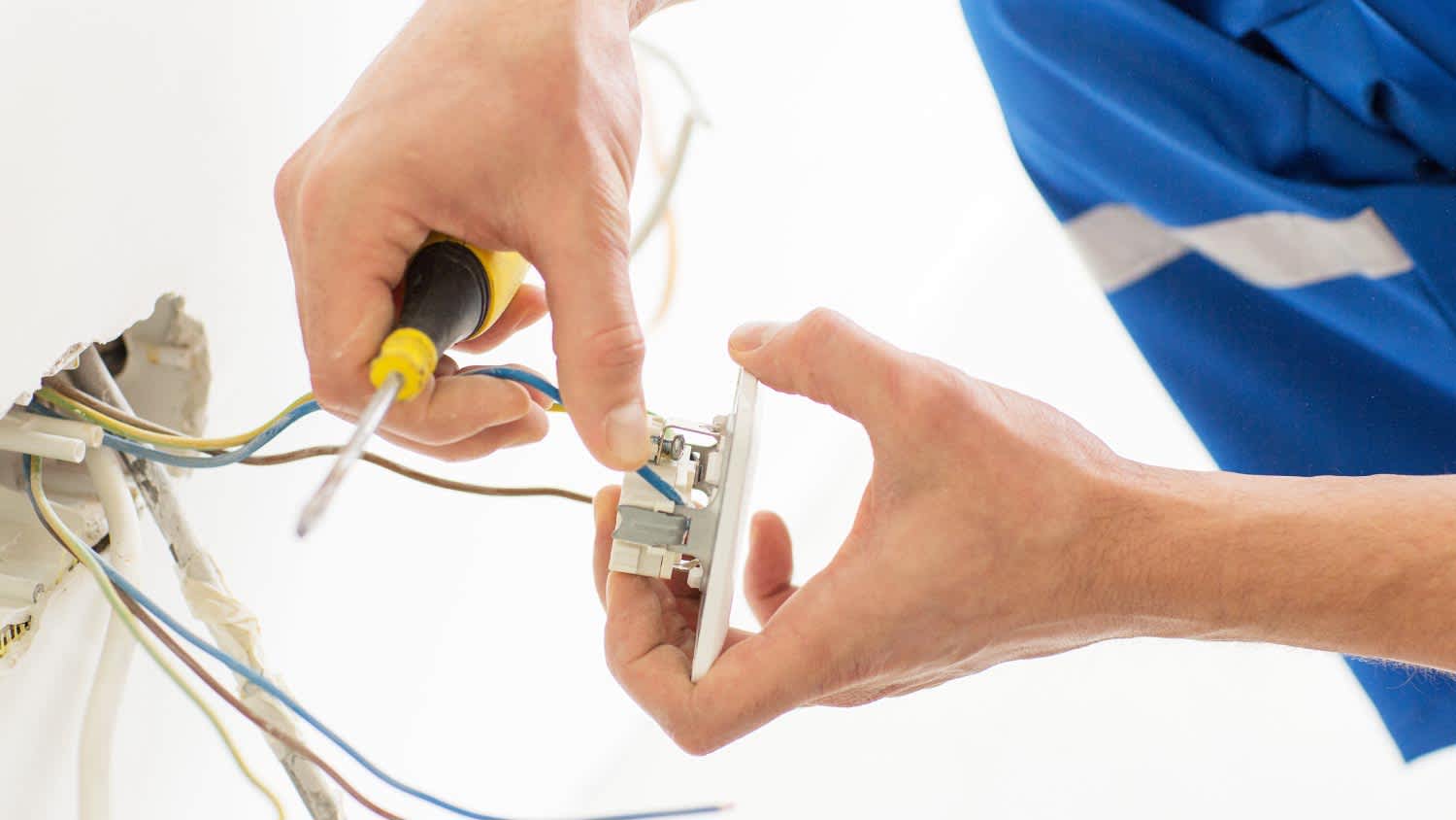 Close up of hands with screwdriver fixing socket