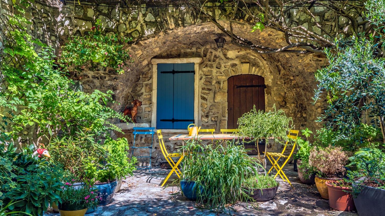 The exterior of a hobbit house with a beautiful yard