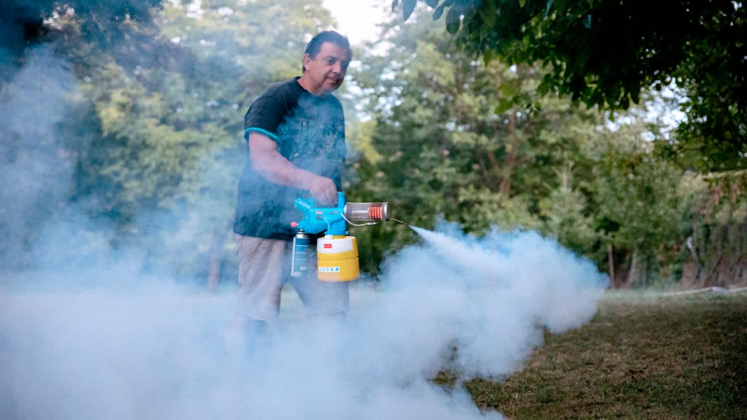 A man mosquito spraying a yard