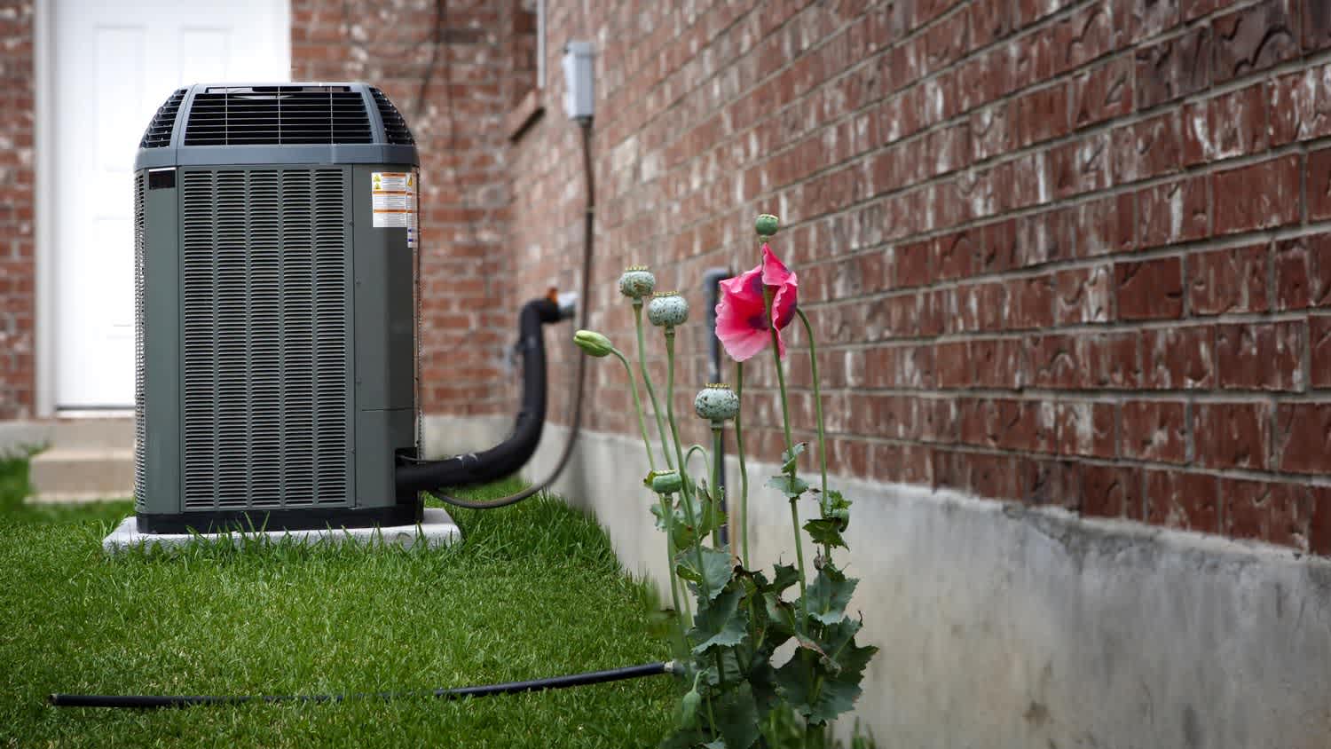 The outside AC unit in a house’s backyard
